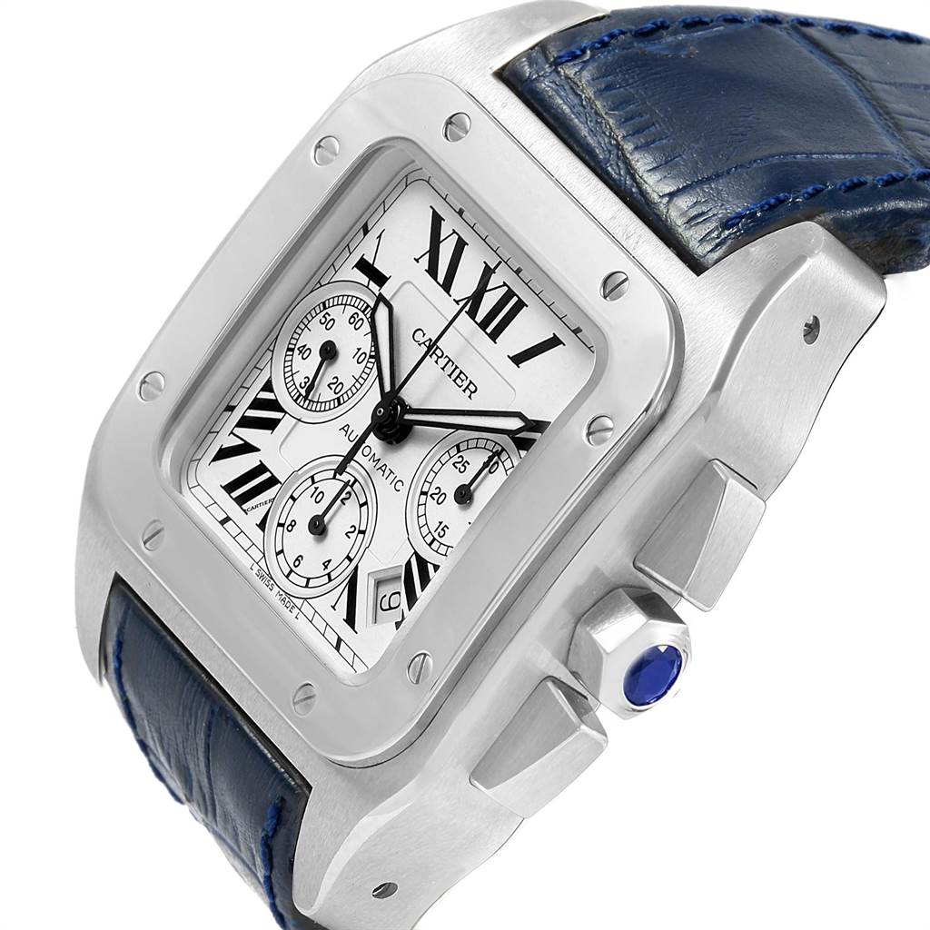 The image shows an angled view of a Cartier Santos W20090X8 Men's Stainless Steel Silver Dial W20090X8 Men's Stainless Steel Silver Dial watch, highlighting its face, bezel, crown, and blue leather strap.