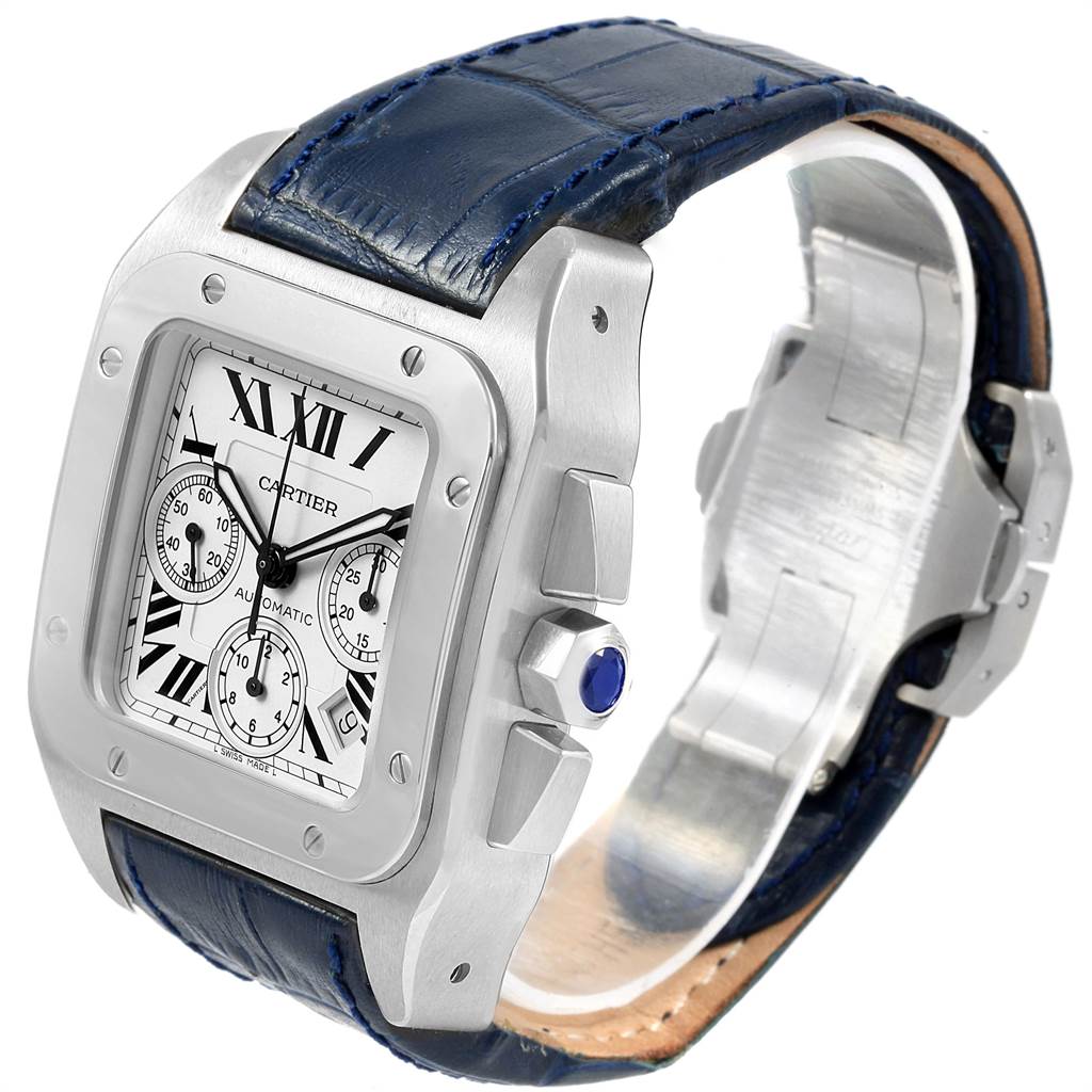The image shows a Cartier Santos W20090X8 Men's Stainless Steel Silver Dial W20090X8 Men's Stainless Steel Silver Dial watch at a slight angle, highlighting its dial, case, blue leather strap, and gemstone-set crown.