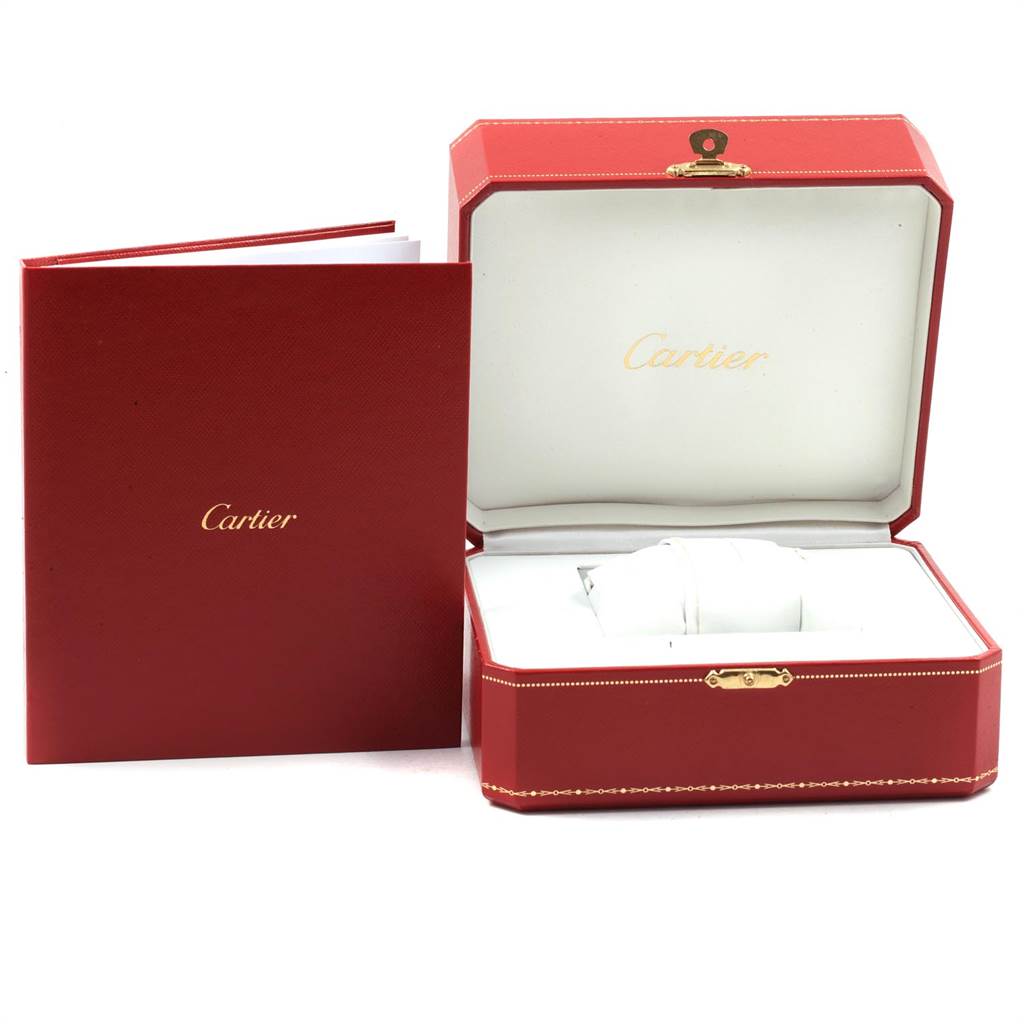 The image shows the Santos model by Cartier in an open red box with a Cartier booklet next to it.