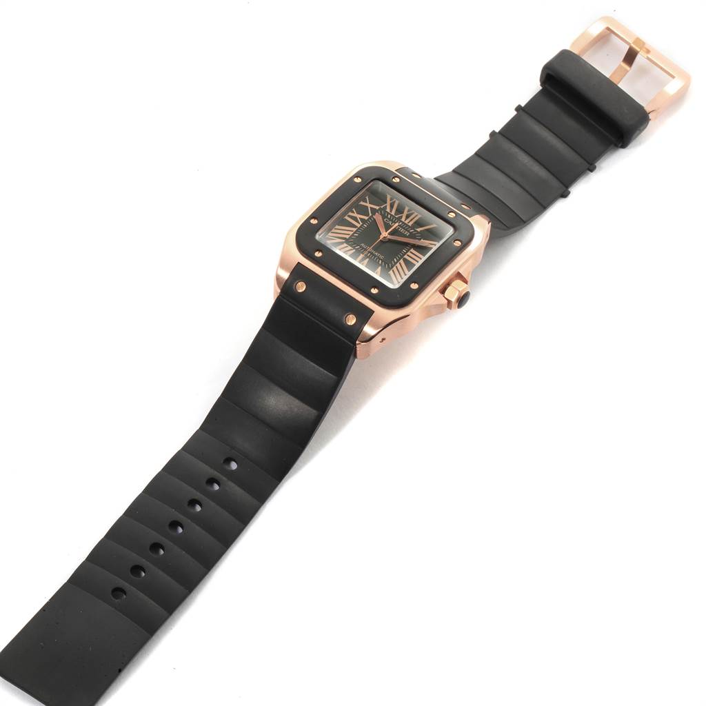 The image shows a Cartier Santos W20124U2 Men
s Rose Gold Black Dial W20124U2 Men
s Rose Gold Black Dial watch at a diagonal angle, highlighting the face, case, and black rubber strap with buckle.