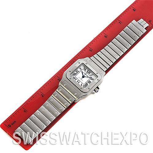 The Cartier Santos W20098D6 Stainless Steel Silver Dial W20098D6 Stainless Steel Silver Dial watch is shown fully extended, laid flat, including its face and bracelet, measured against a red ruler.