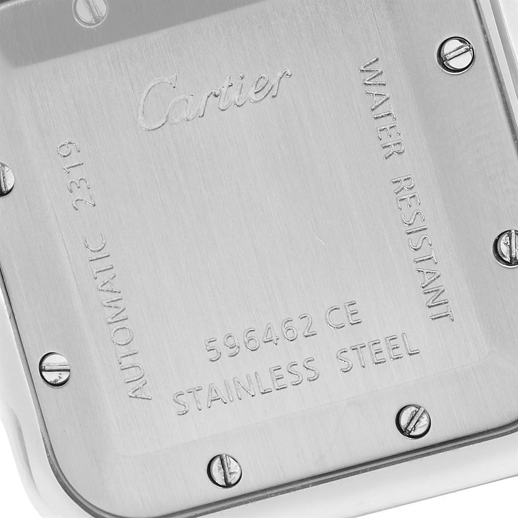 This image shows the back case of a Santos model watch by Cartier, highlighting its engravings and screws.