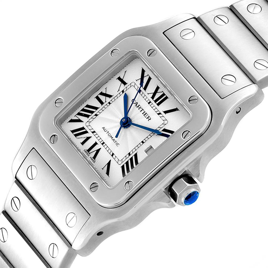 The image shows a close-up, angled view of the Cartier Santos W20055D6 Men's Silver Dial W20055D6 Men's Silver Dial watch, highlighting the face, bezel, bracelet, and sapphire crown.