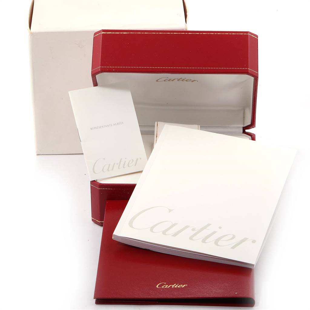 This image shows the packaging and manuals for a Santos model by Cartier, including a red box and white paperwork.