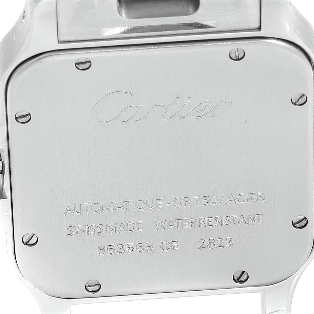 This image shows the back case of a Cartier Santos W20099C4 Stainless Steel Silver Dial W20099C4 Stainless Steel Silver Dial watch with engraving and four screw heads visible.