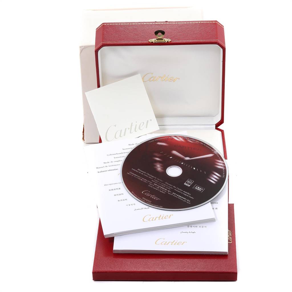 The image shows the packaging of a Cartier Santos W20099C4 Stainless Steel Silver Dial W20099C4 Stainless Steel Silver Dial watch, including a red box, documents, and a CD.