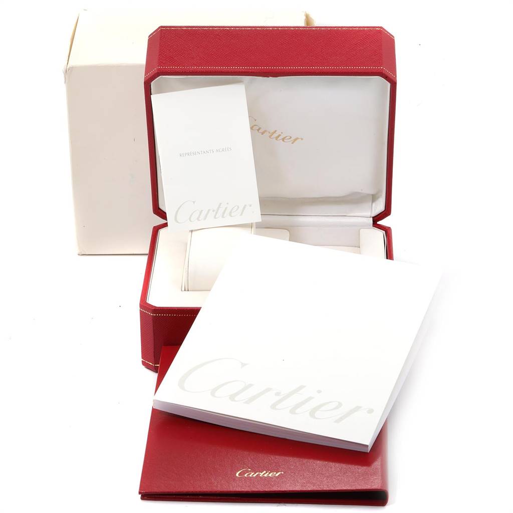The image shows an open Cartier watch box for the Santos model, along with accompanying booklets and documents.