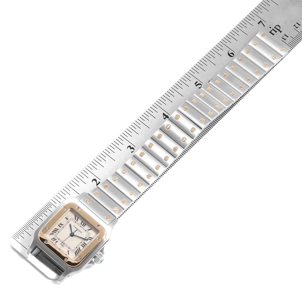 The image shows a Cartier Santos W20011C4 Stainless Steel Silver Dial W20011C4 Stainless Steel Silver Dial model watch face and part of its bracelet, measured against a ruler for size reference.