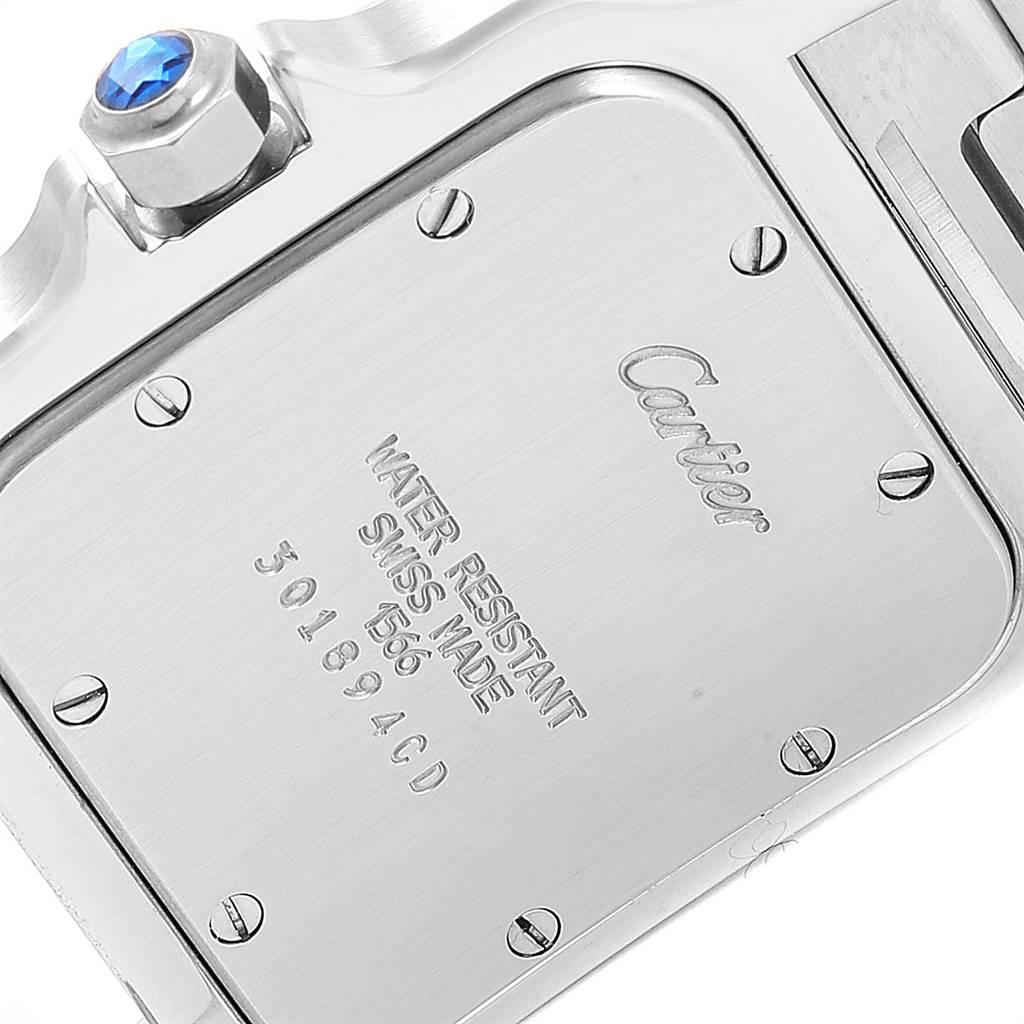 The image shows the back case and part of the crown of a Cartier Santos W20011C4 Stainless Steel Silver Dial W20011C4 Stainless Steel Silver Dial watch.