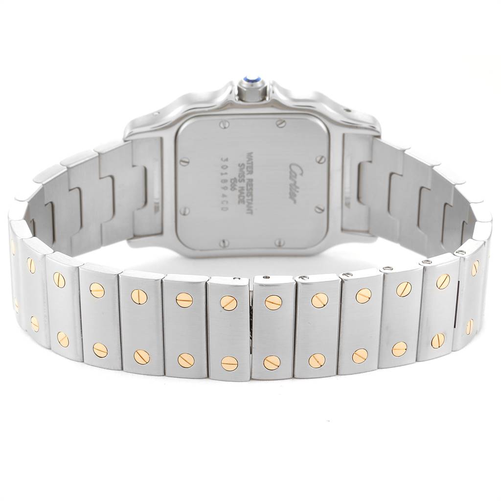 The image shows the back view of a Santos model watch by Cartier, highlighting the case back and the bracelet with gold screw accents.