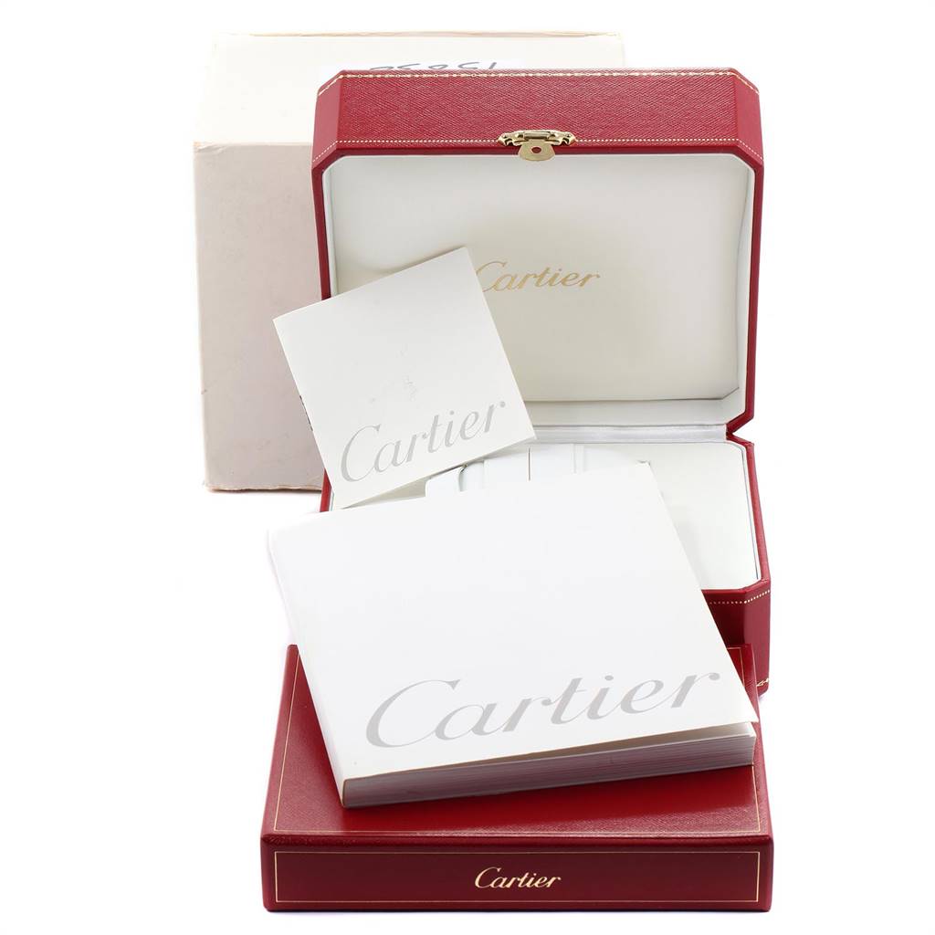 The image shows the box and documentation for the Santos model by Cartier, with the red watch box open and visible.