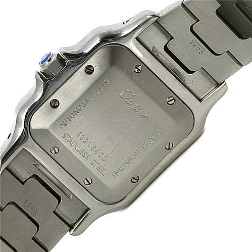 The image shows the case back and part of the bracelet of a Cartier Santos Stainless Steel Silver Dial Stainless Steel Silver Dial watch, with the engraving and screws visible.