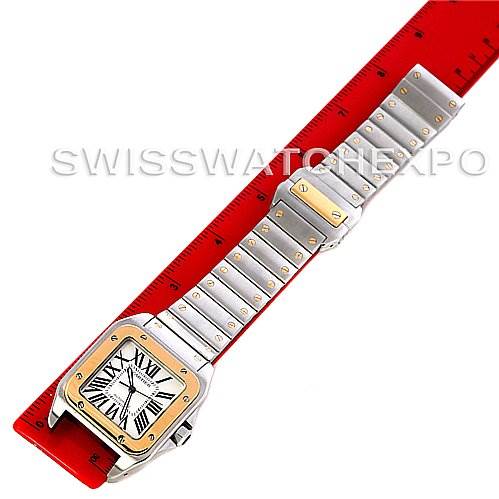 The image shows a Santos model by Cartier, highlighting the watch face and full-length metal bracelet at a top-down angle.
