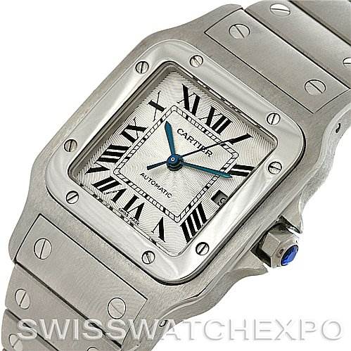 The image shows a close-up angle of the Cartier Santos W20055D6 Men
s Stainless Steel Silver Dial W20055D6 Men
s Stainless Steel Silver Dial watch, highlighting the case, dial, bracelet, and crown with a blue gem.