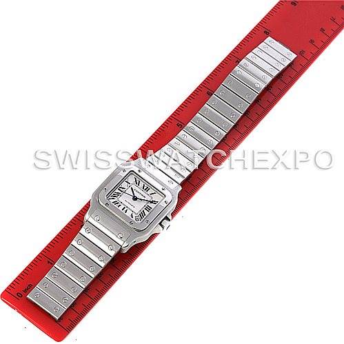 The image displays the full Santos model watch by Cartier, viewed from above, placed along a red ruler for measurement.