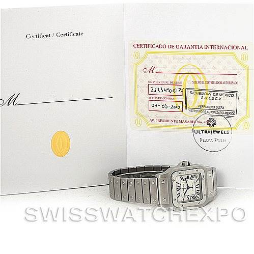 This image shows a Cartier Santos W20098D6 Men's Stainless Steel Silver Dial W20098D6 Men's Stainless Steel Silver Dial watch, lying flat with its face and band fully visible, alongside its warranty certificate.
