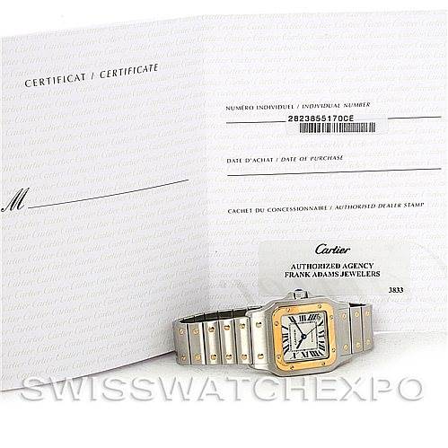 The image shows a Cartier Santos W20099C4 Men
s Stainless Steel Silver Dial W20099C4 Men
s Stainless Steel Silver Dial watch and associated certification documents at an angle displaying the watch face and bracelet.