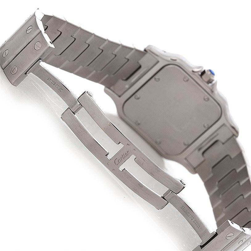 The image shows the back side and clasp of a Santos model by Cartier, highlighting the stainless steel bracelet.