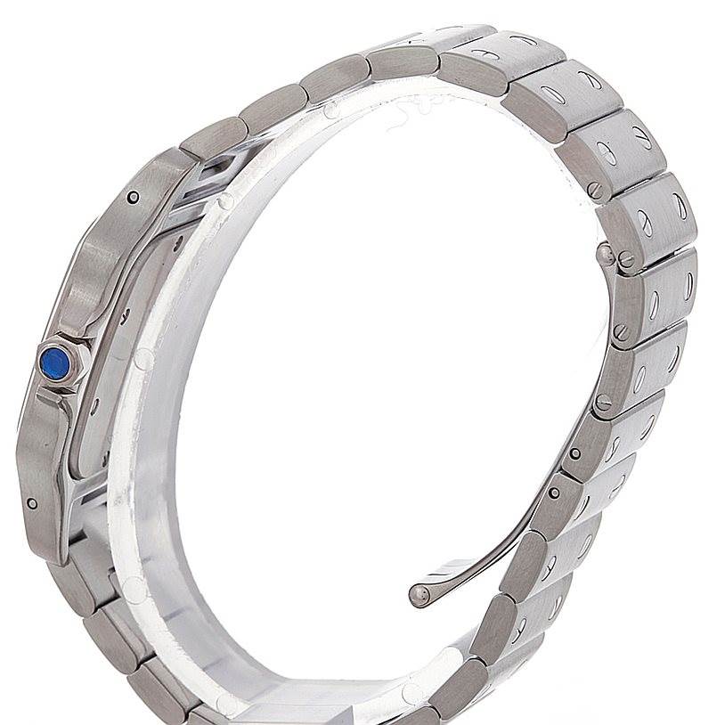 The image shows a side view of the Santos model by Cartier, highlighting the bracelet, case, and crown with a blue cabochon.
