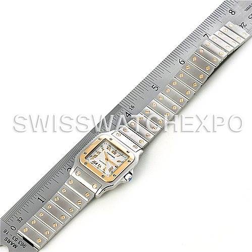 This image shows the entire Santos model watch by Cartier laid flat with a ruler for scale.