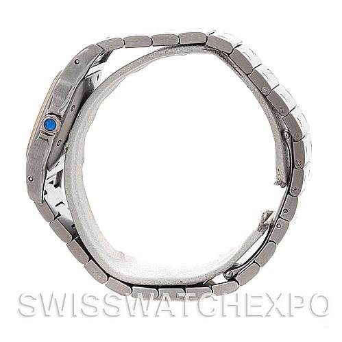 The image shows a side view of the Santos model by Cartier, highlighting its case, bracelet, and crown with a blue gemstone.