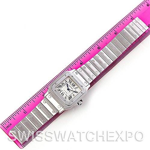 This image shows a Cartier Santos W20055D6 Men
s Stainless Steel Silver Dial W20055D6 Men
s Stainless Steel Silver Dial watch with a metallic bracelet, displayed next to a pink ruler for size reference.