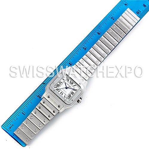 The image shows a top-down view of a Cartier Santos W20098D6 Men
s Stainless Steel Silver Dial W20098D6 Men
s Stainless Steel Silver Dial watch next to a blue ruler for size reference.
