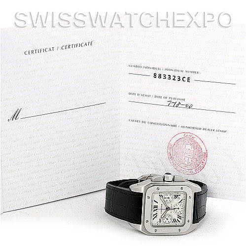 The image shows a Cartier Santos W20090X8 Men's Stainless Steel Silver Dial W20090X8 Men's Stainless Steel Silver Dial watch with a black strap and its certificate from an angled, front-facing perspective.