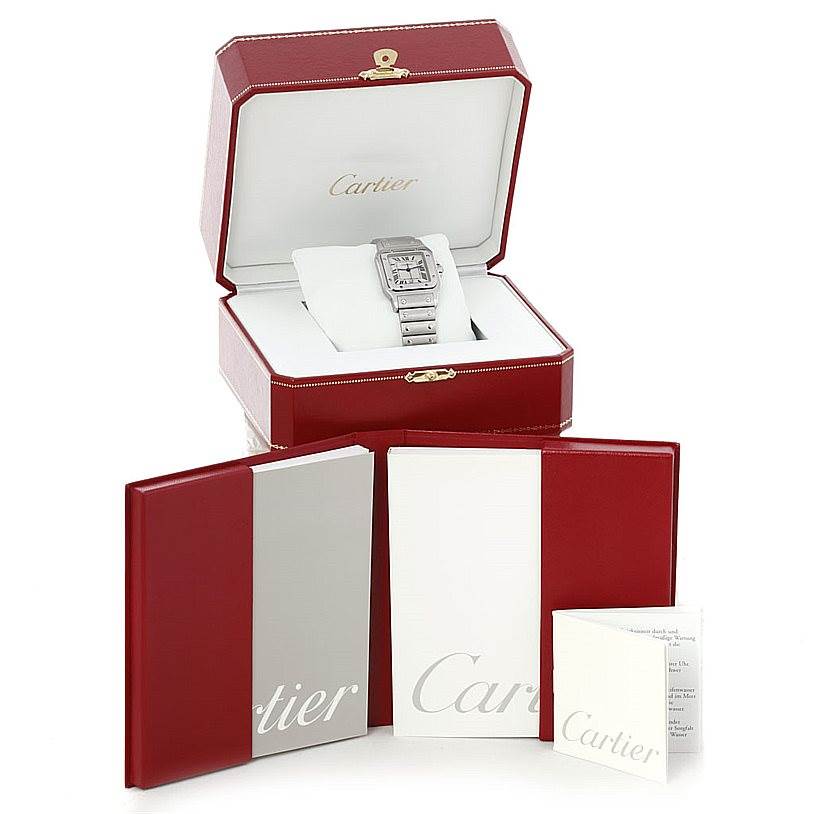 The image shows a Santos model by Cartier with a steel band in an open branded box, accompanied by manuals and documents.