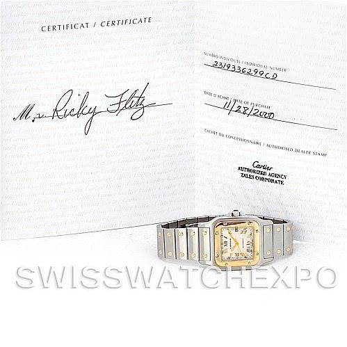 The image shows a Cartier Santos W20058C4 Men
s Stainless Steel Silver Dial W20058C4 Men
s Stainless Steel Silver Dial watch displayed with its certification papers at an angle.