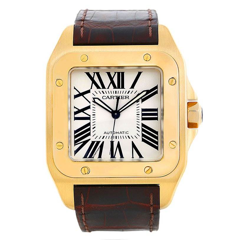 The image shows a front view of a Cartier Santos W20071Y1 Men's Yellow Gold Silver Dial W20071Y1 Men's Yellow Gold Silver Dial model watch with a gold case, white dial, Roman numerals, and leather strap.