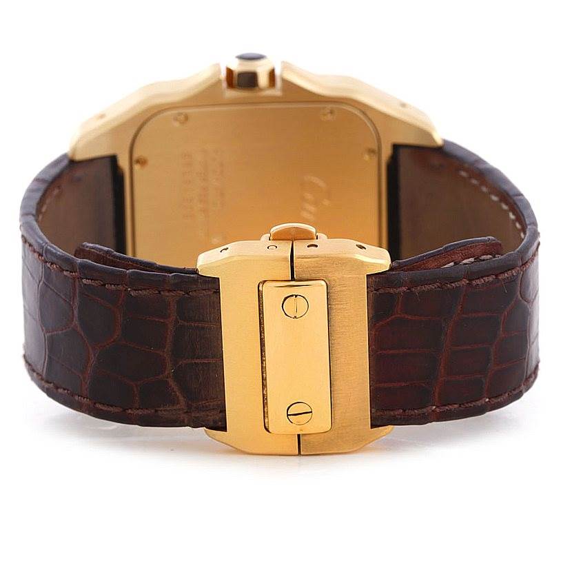 This image shows the back and clasp of a Cartier Santos W20071Y1 Men's Yellow Gold Silver Dial W20071Y1 Men's Yellow Gold Silver Dial watch, highlighting the gold case and brown leather strap.