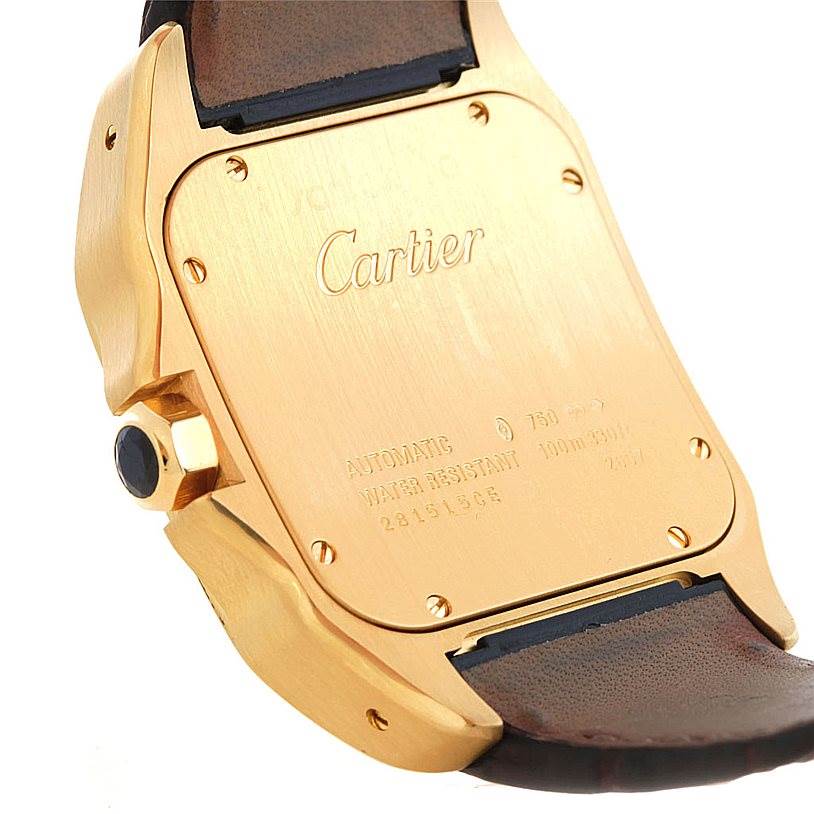 This image shows the back case and part of the strap of a Cartier Santos W20071Y1 Men's Yellow Gold Silver Dial W20071Y1 Men's Yellow Gold Silver Dial model watch.