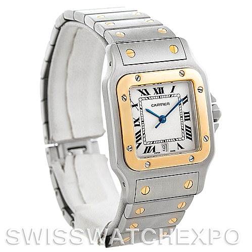 The image shows a Santos model watch by Cartier featuring a two-tone bezel and metal bracelet, displayed at a three-quarter view angle.