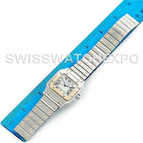 The image shows the Cartier Santos W20011C4 Men's Stainless Steel Silver Dial W20011C4 Men's Stainless Steel Silver Dial watch laid flat next to a ruler, displaying the face and entire bracelet.