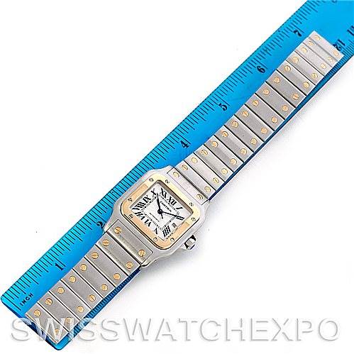 The image shows a Cartier Santos W20058C4 Men
s Stainless Steel Silver Dial W20058C4 Men
s Stainless Steel Silver Dial watch laid flat, displaying the watch face and entire bracelet next to a blue ruler for scale.