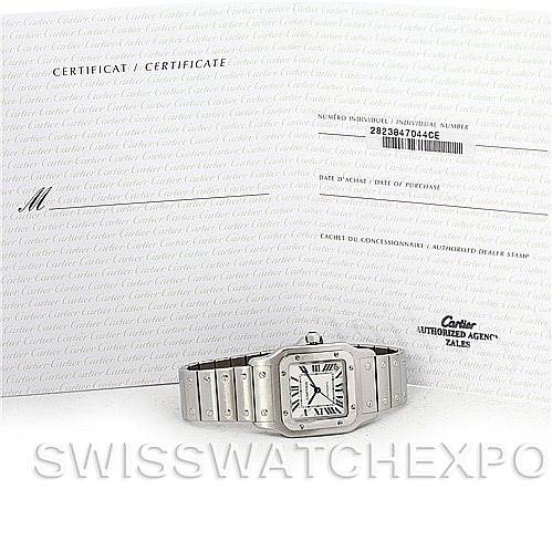 The image shows a Cartier Santos W20098D6 Men
s Stainless Steel Silver Dial W20098D6 Men
s Stainless Steel Silver Dial watch placed in front of its certificate and authorized dealer document, viewed from a front angle.