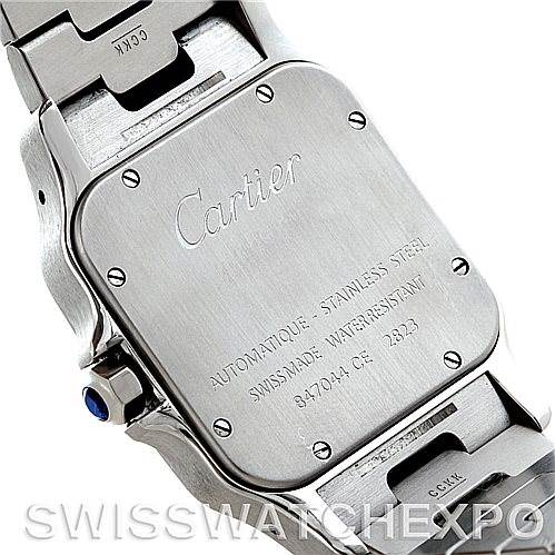 The image shows the back case of a Santos model watch by Cartier, highlighting its stainless steel finish and engraving.