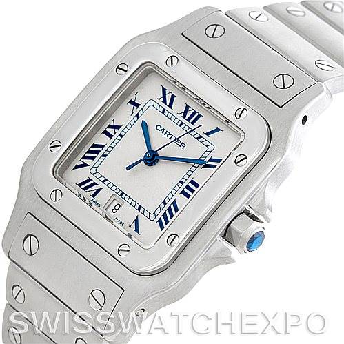 The image shows a close-up of a Cartier Santos W20060D6 Men's Stainless Steel Silver Dial W20060D6 Men's Stainless Steel Silver Dial watch displaying the face, bezel, and part of the strap at an angled perspective.