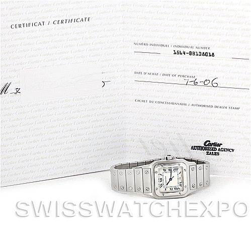 The image shows a Cartier Santos W20060D6 Men's Stainless Steel Silver Dial W20060D6 Men's Stainless Steel Silver Dial watch lying flat with its certificate displayed in the background.