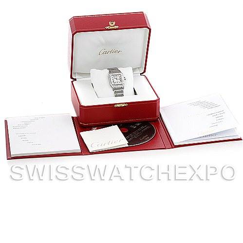 The image shows a Cartier Santos W20060D6 Men's Stainless Steel Silver Dial W20060D6 Men's Stainless Steel Silver Dial watch in its box with accompanying booklets and accessories displayed around it.