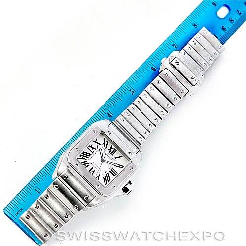 The image shows a full view of the Cartier Santos W200737G Men's Stainless Steel Silver Dial W200737G Men's Stainless Steel Silver Dial watch laid flat next to a ruler, displaying the face, bezel, case, and bracelet.