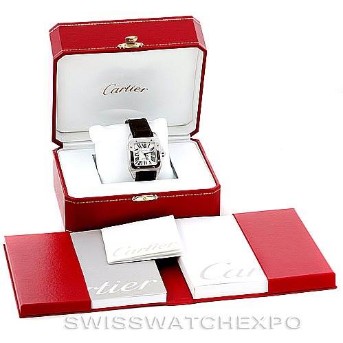 The image shows a Cartier Santos W20106X8 Men
s Stainless Steel Silver Dial W20106X8 Men
s Stainless Steel Silver Dial watch placed in its open red box, with additional Cartier packaging and booklets displayed in front.