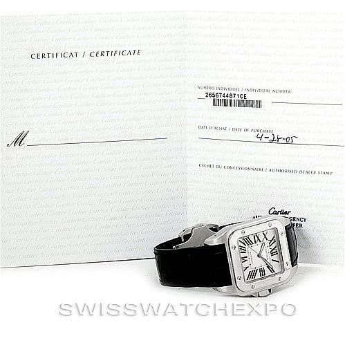The image shows a Cartier Santos W20073X8 Stainless Steel Silver Dial W20073X8 Stainless Steel Silver Dial watch at an angle displaying its face and part of the strap, along with its certificate.