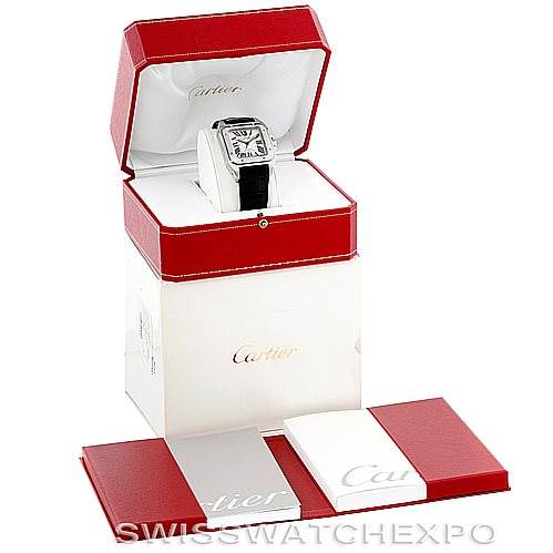 The image shows a Cartier Santos W20073X8 Stainless Steel Silver Dial W20073X8 Stainless Steel Silver Dial watch in a red and white box, along with accompanying booklets.