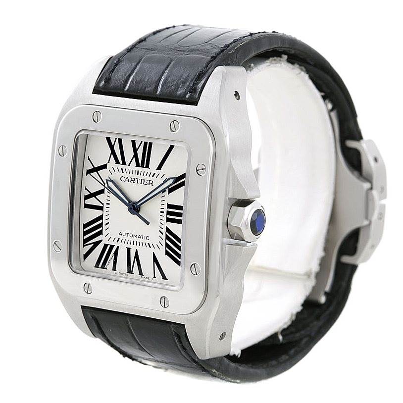 The Cartier Santos W20073X8 Men's Stainless Steel Silver Dial W20073X8 Men's Stainless Steel Silver Dial watch is shown at an angle highlighting the face, bezel, crown, and leather strap.