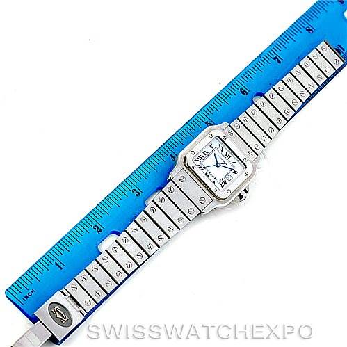 The image shows the Santos model by Cartier, including the watch face and entire bracelet, placed alongside a blue ruler for scale.