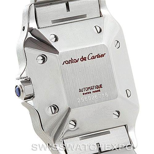 The image shows the case back of the Santos de Cartier watch, including the crown with a blue cabochon, screws, and part of the bracelet.