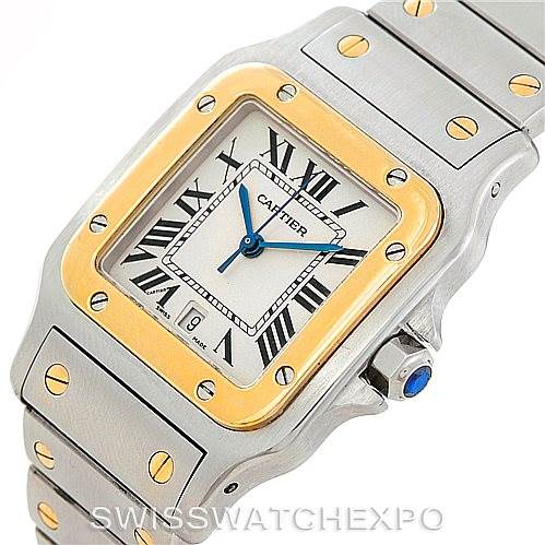 The image shows a Cartier Santos W20011C4 Men
s Stainless Steel Silver Dial W20011C4 Men
s Stainless Steel Silver Dial watch at a slight angle, highlighting its square face, bezel, bracelet, and crown with a blue cabochon.
