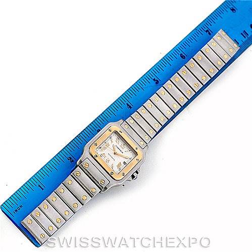 The image shows a top-down view of a Cartier Santos W20058C4 Men's Stainless Steel Silver Dial W20058C4 Men's Stainless Steel Silver Dial watch with a ruler for scale.